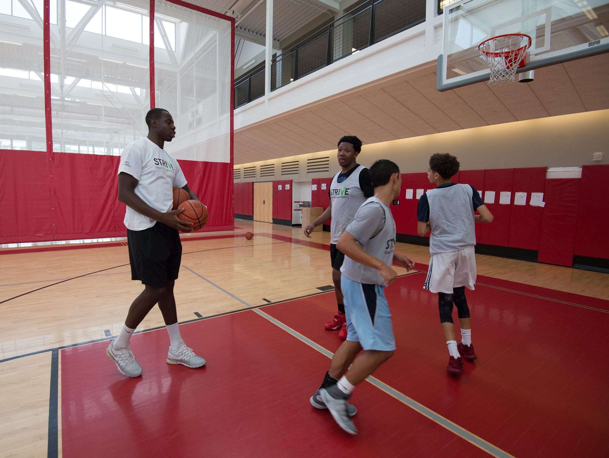 St. Andrew's School alumni, Eric Boateng, working with basketball players during the Strive Sports Challenge at St. Andrew's School in Middletown, Del,.