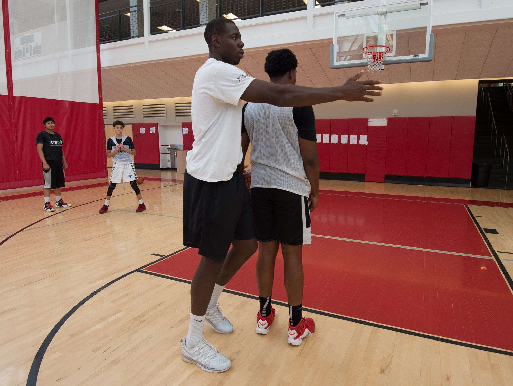 St. Andrew's School alumni, Eric Boateng, working with basketball players during the Strive Sports Challenge at St. Andrew's School in Middletown, Del,.