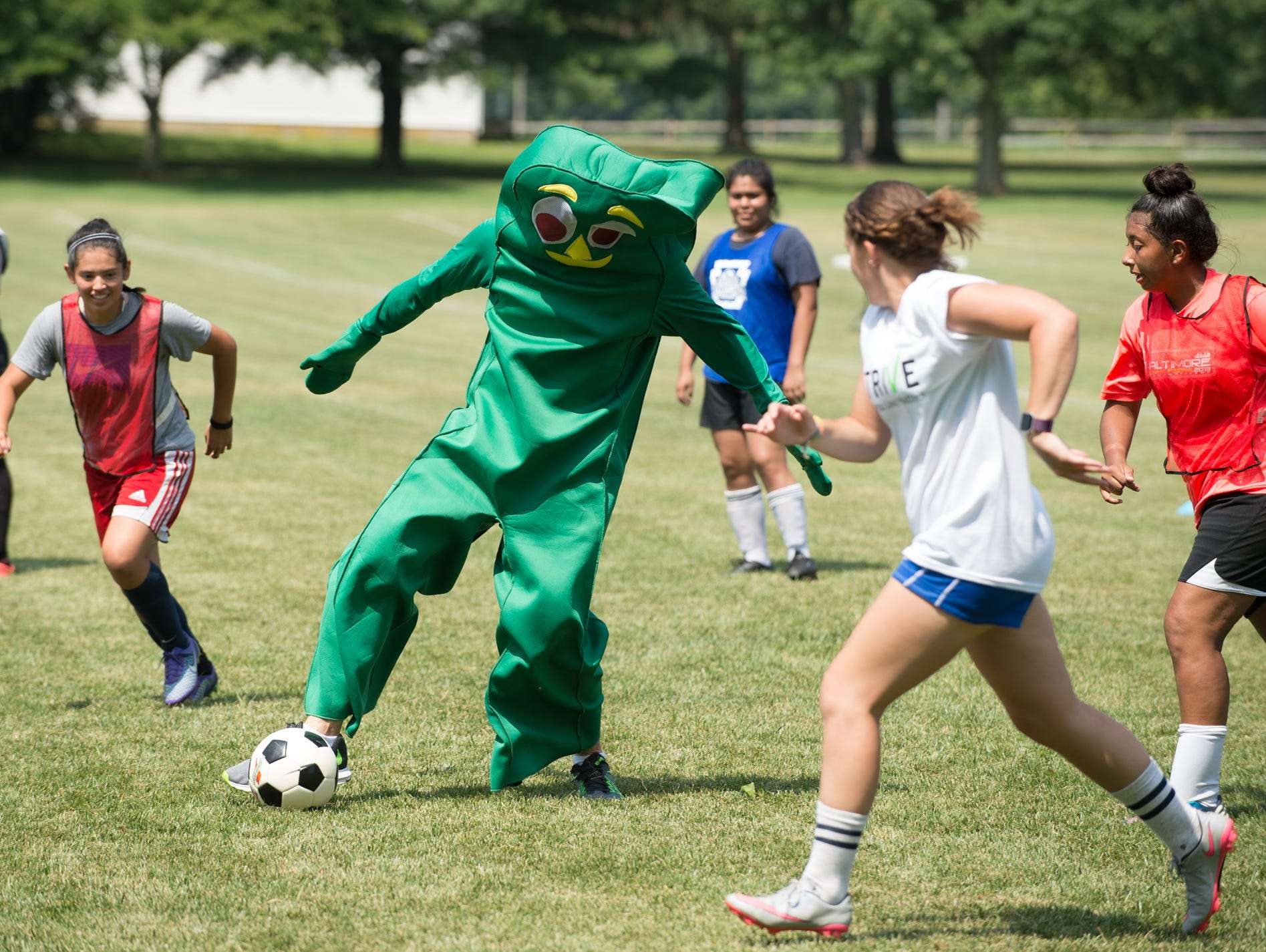 Jeremy Edwards, co-founder of Strive, plays soccer dressed as Gumby at St. Andrew's School in Middletown, Del,.