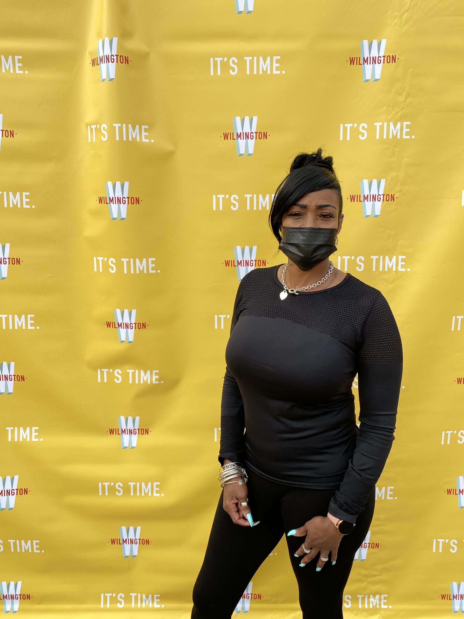 woman in front of step and repeat