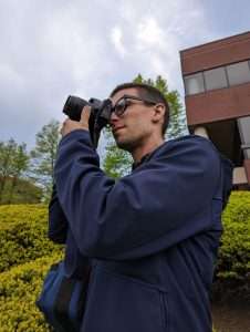 Jesse Simmons taking a photo outside